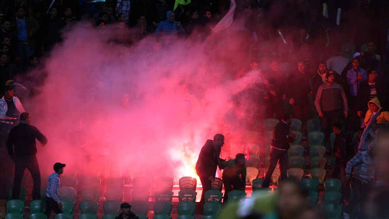 Flares are thrown in the stadium during clashes that erupted after the match between Al-Ahly and Al-Masry in Port Said.