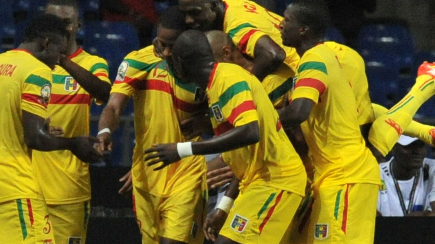 Mali players surround Seydou Keita after he scores the winning goal in their 2-1 victory over Botswana.
