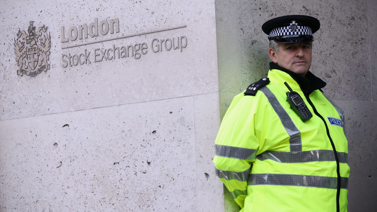 A police officer stands guard in front of the London Stock Exchange, October 17, 2011.