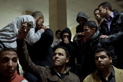 Family members and mourners gather at Cairo's railway station as they receive the bodies of football fans killed during clashes between rival fans in Port Said.