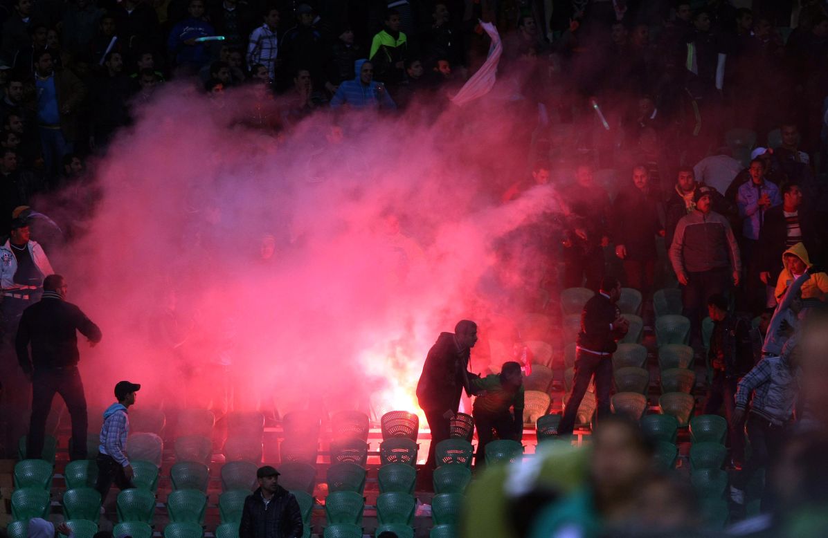 Flares are thrown in the stadium as tension builds throughout the game.