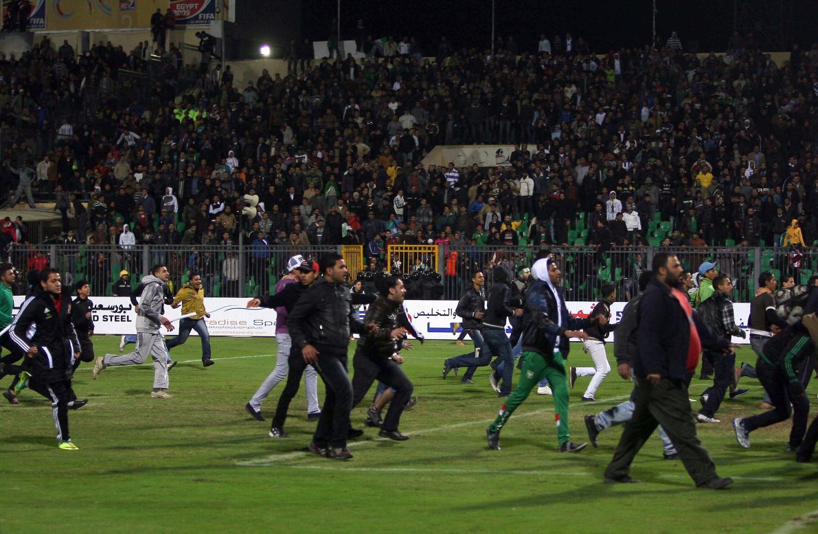 Egyptian football fans rush on to the field during the clashes.