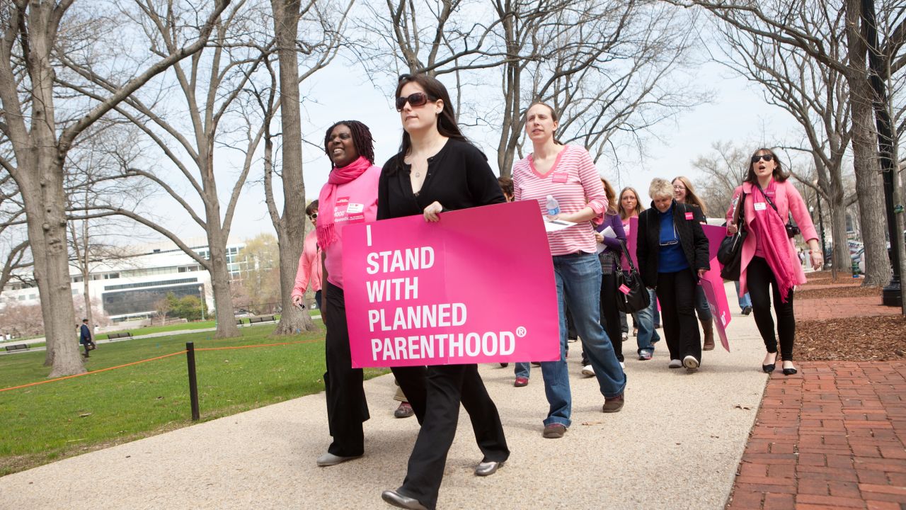 Planned Parenthood supporters walk to a rally on Capitol Hill on April 7, 2011.