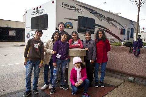 Kids from an orphanage in  Afghanistan pose in front of an RV in Atlanta. They have started a road trip from Massachusetts to California and places in between. The kids are among an estimated 2 million children living without parents in Afghanistan. Each has a special story.