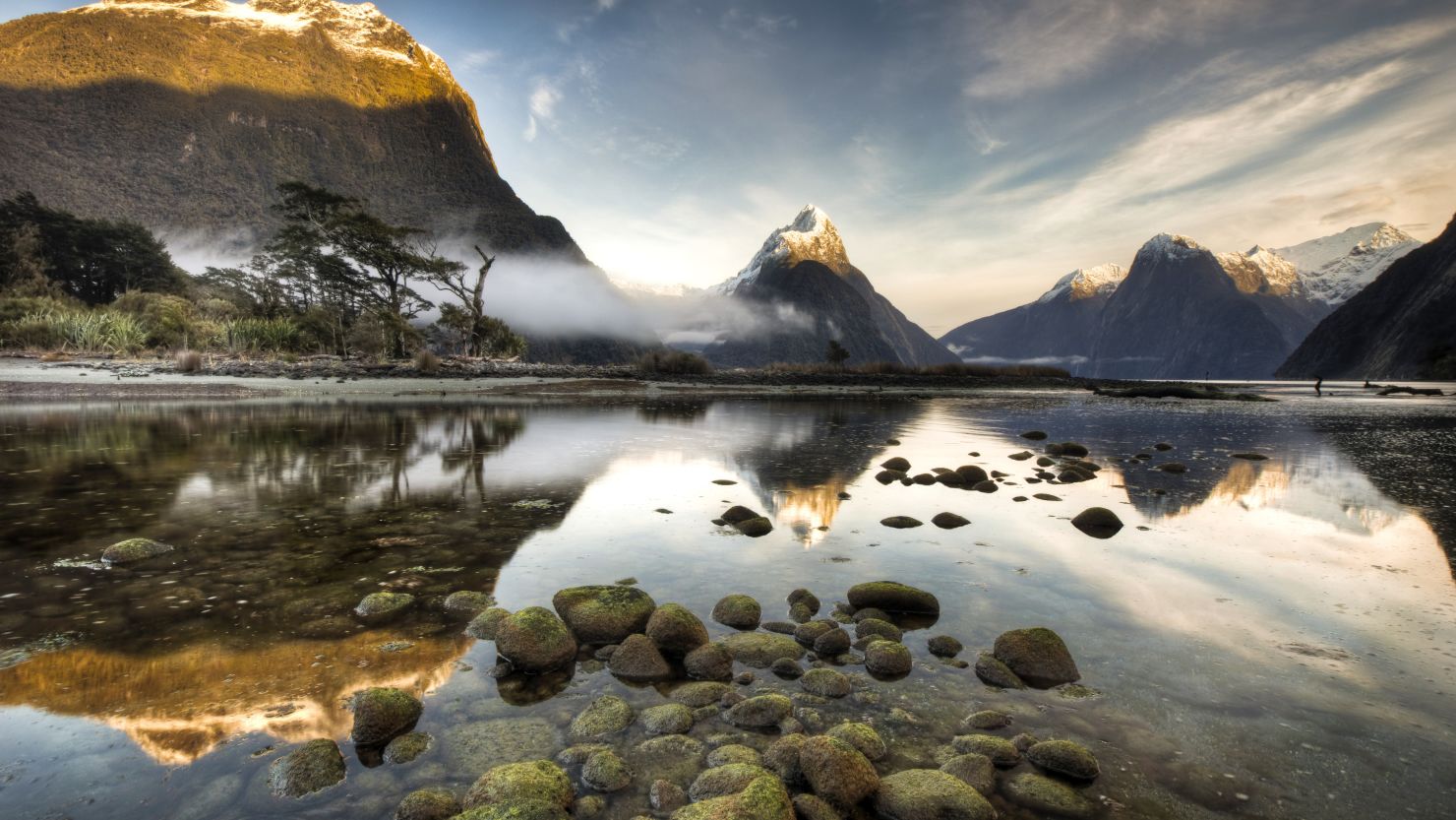 Dawn breaks during winter at Mitre Peak in Milford Sound, the most famous of the 15 fiords in Fiordland National Park.