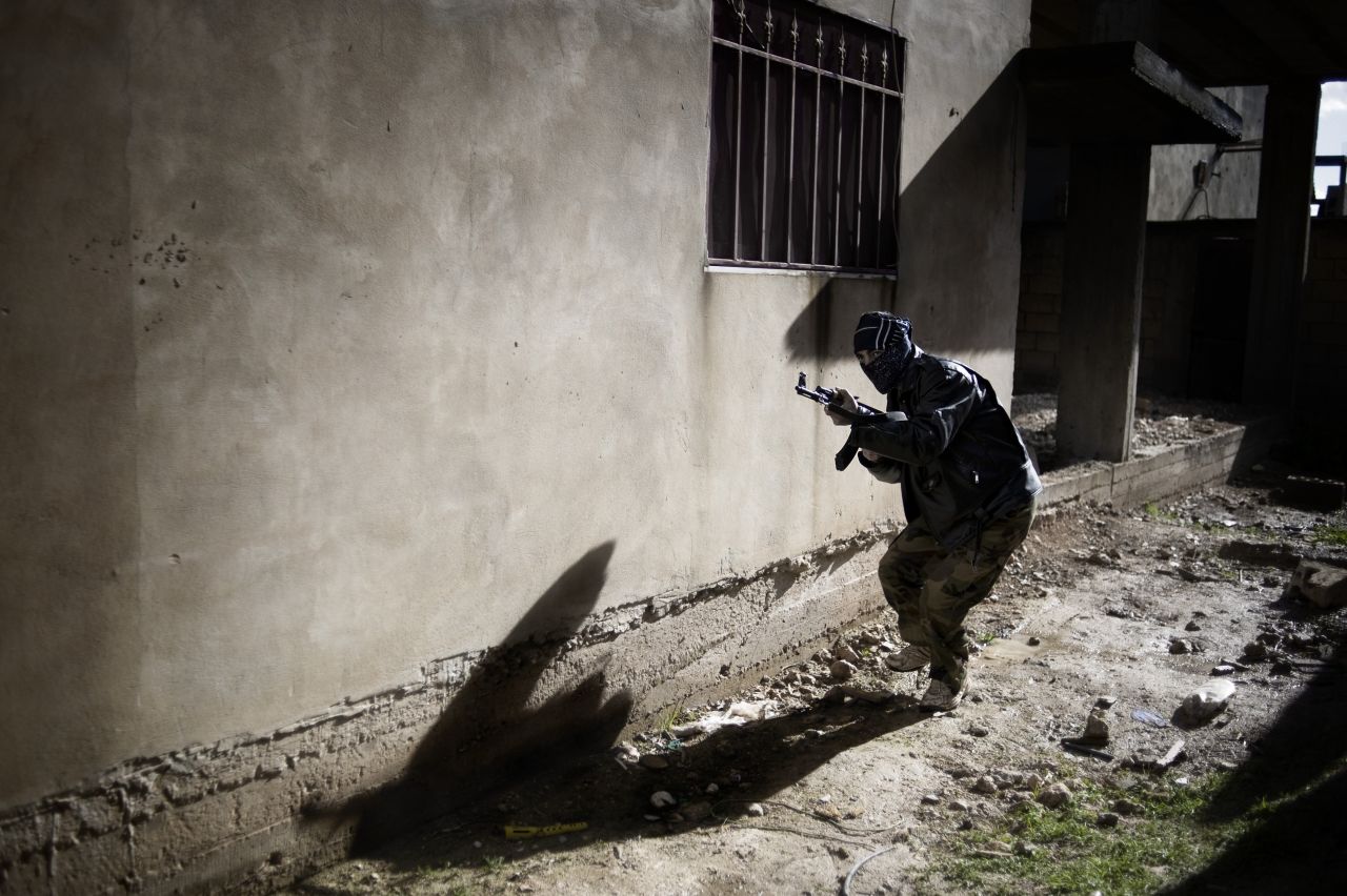 A member of the Free Syrian Army engages in an attack against the Syrian army in Al-Qusayr on January 27. The small town in western Syria has been under siege since early November.