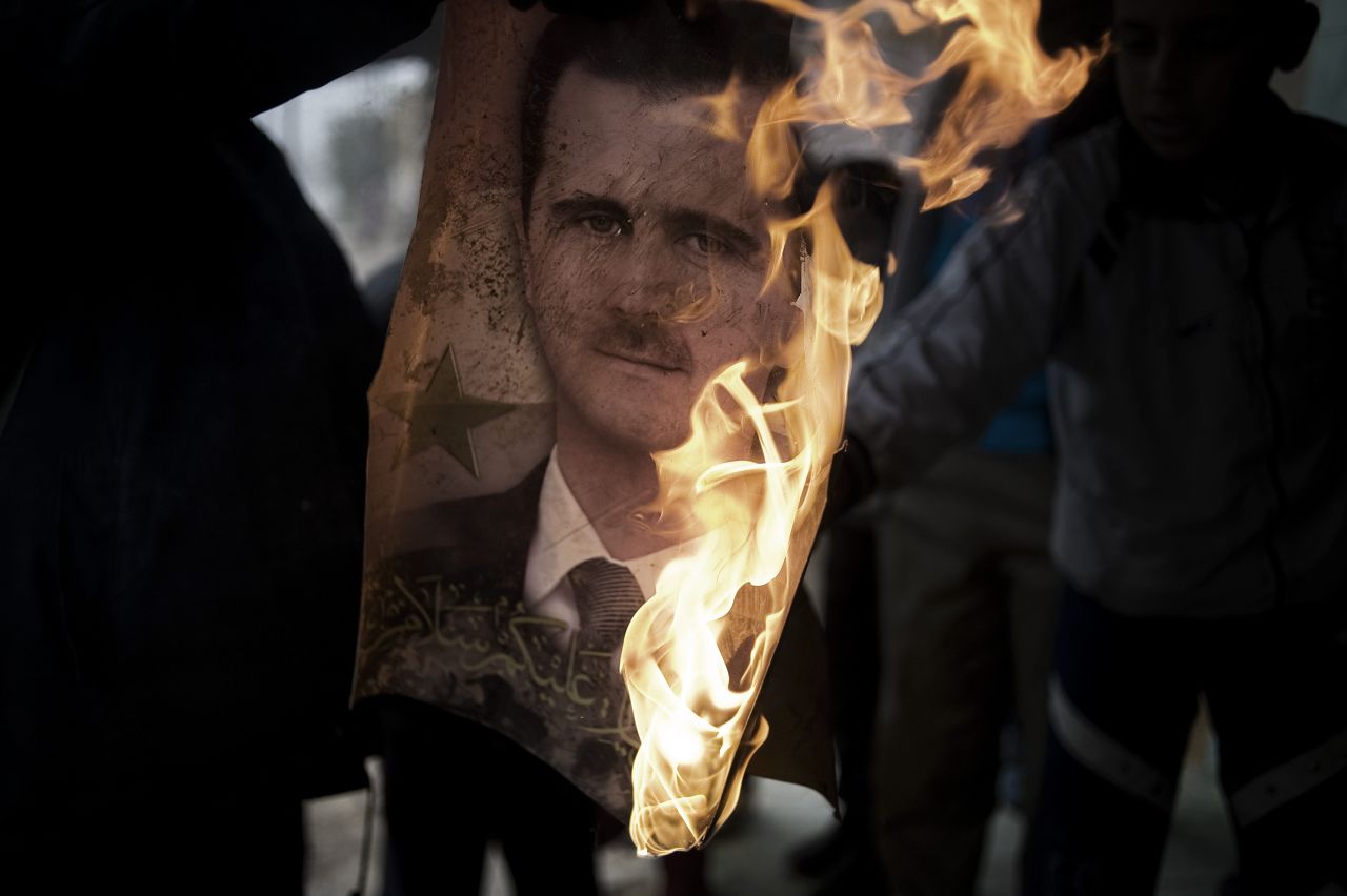 Syrians burn a portrait of President Bashar al-Assad in Al-Qusayr. The Syrian regime has faced international pressure to stop its crackdown on protesters. Some have asked for al-Assad to step down.