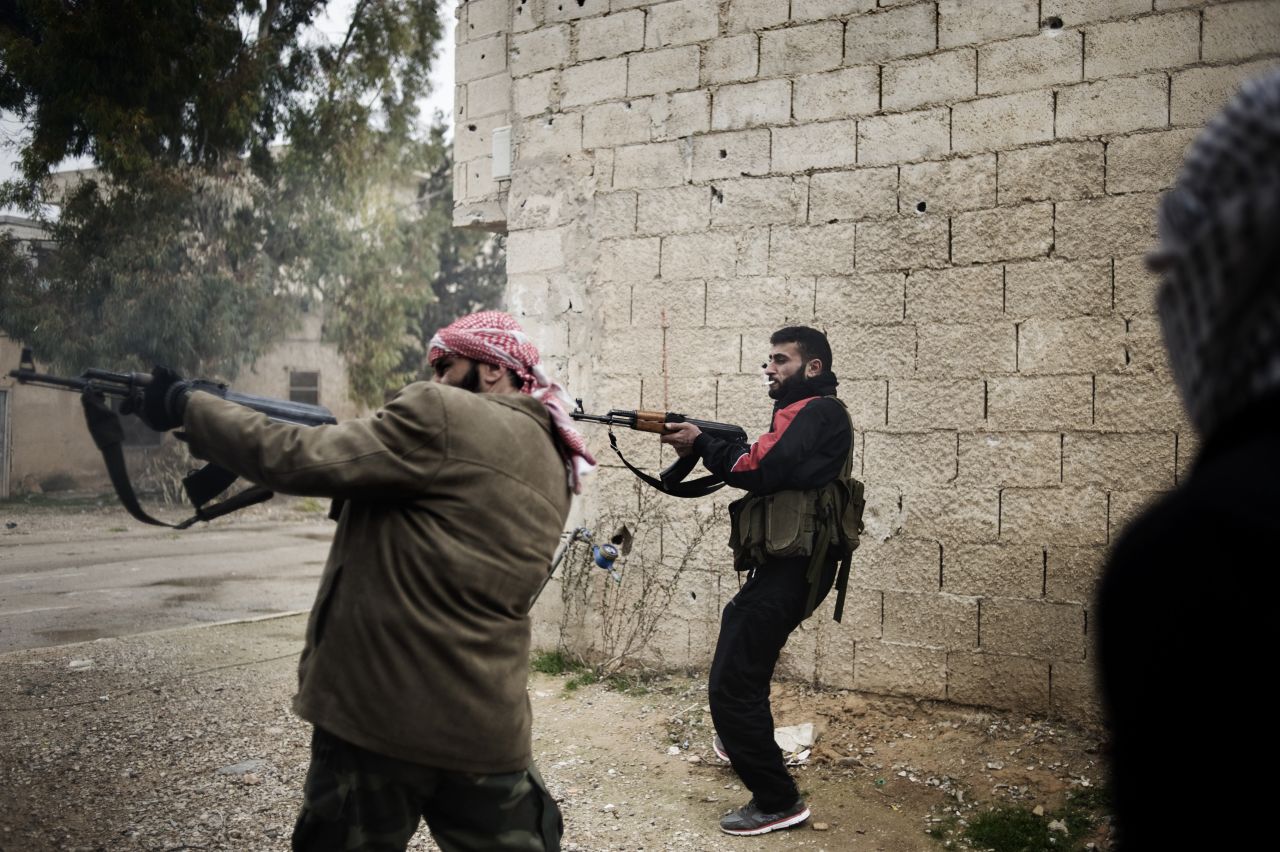 Opposition fighters fire on Syrian soldiers on January 24. Syria has seen a sharp increase in violence in recent weeks, with hundreds killed in clashes between government forces, rebels and protesters.