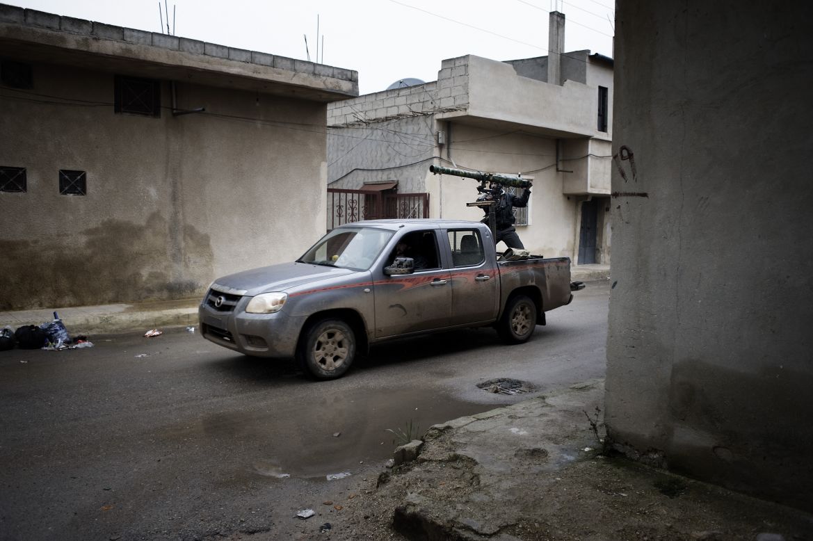 The rebels drive through a neighborhood in Al-Qusayr. The town is close to the flashpoint city of Homs and has about 44,000 residents.