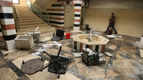 A photographer walks in the damaged reception hall of the Syrian embassy in Cairo, Egypt on February 4, 2012.