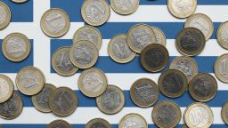 In this photo illustration a Greek flag is covered with one Euro coins on October 4, 2011 in Berlin, Germany.