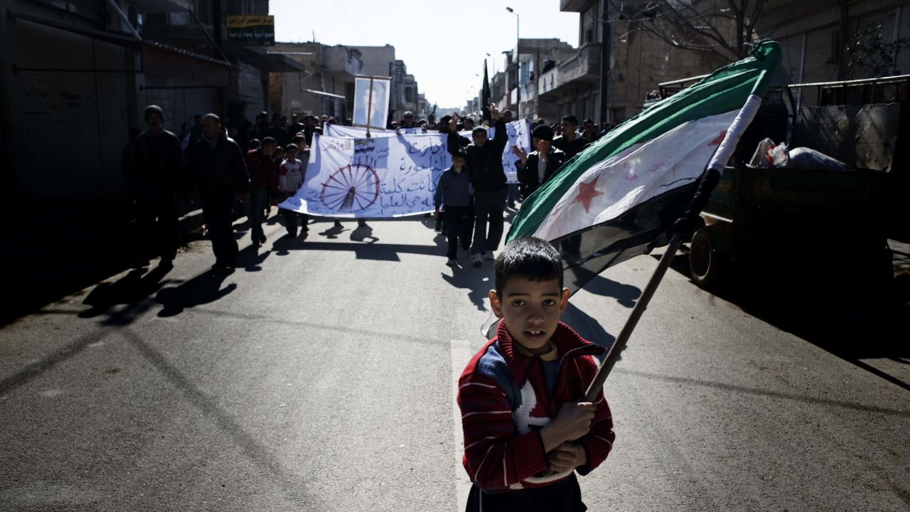 A young boy carries the Syrian rebel-adopted flag during an anti-regime demonstration Friday in al-Qsair.