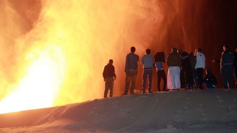 Onlookers stand in front of a fire ball following an attack on a gas pipeline in northern Sinai on February 5.