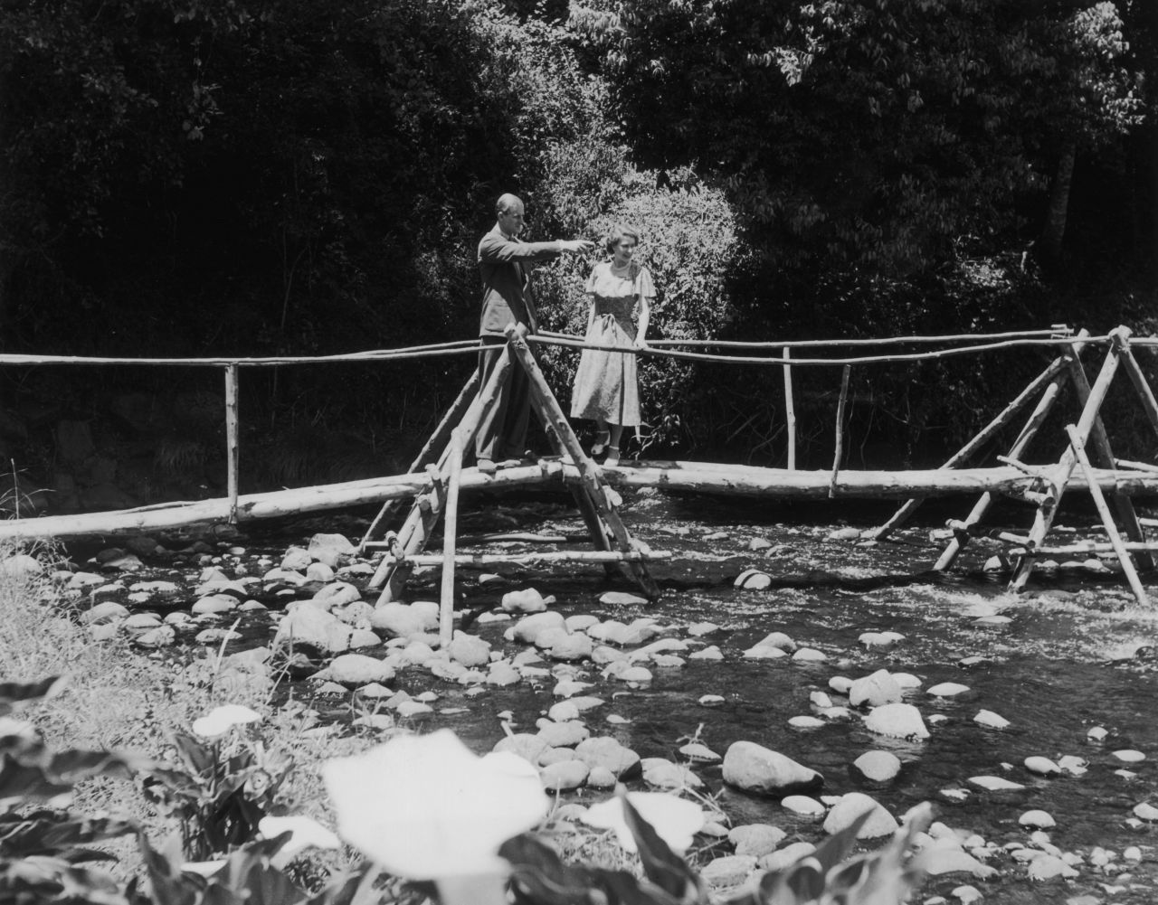 5th February 1952: Princess Elizabeth and the Duke of Edinburgh admiring the view from a bridge in the grounds of Sagana Lodge, their wedding present from the people of Kenya. 