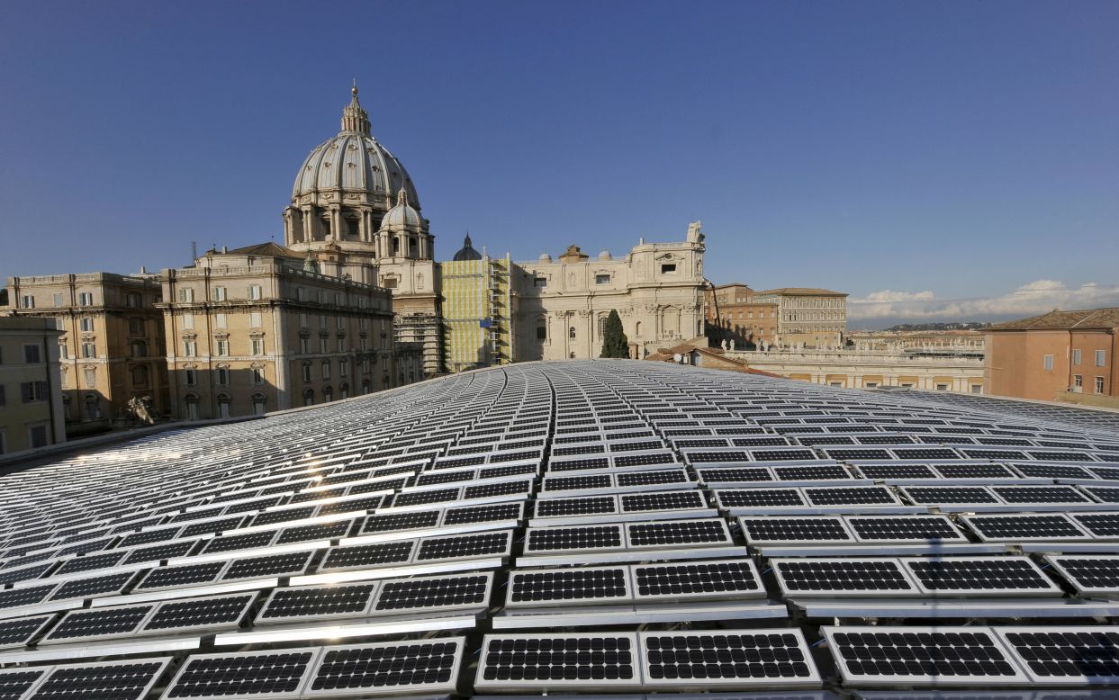 Solar panels shimmer in the sunlight in front of St Peter's Basilica in the Vatican City. One thousand photovoltaic panels cover the roof of the Paul VI Audience Hall that generate enough electricity to meet all heating, lighting and cooling requirements of the 6,300 seat venue.