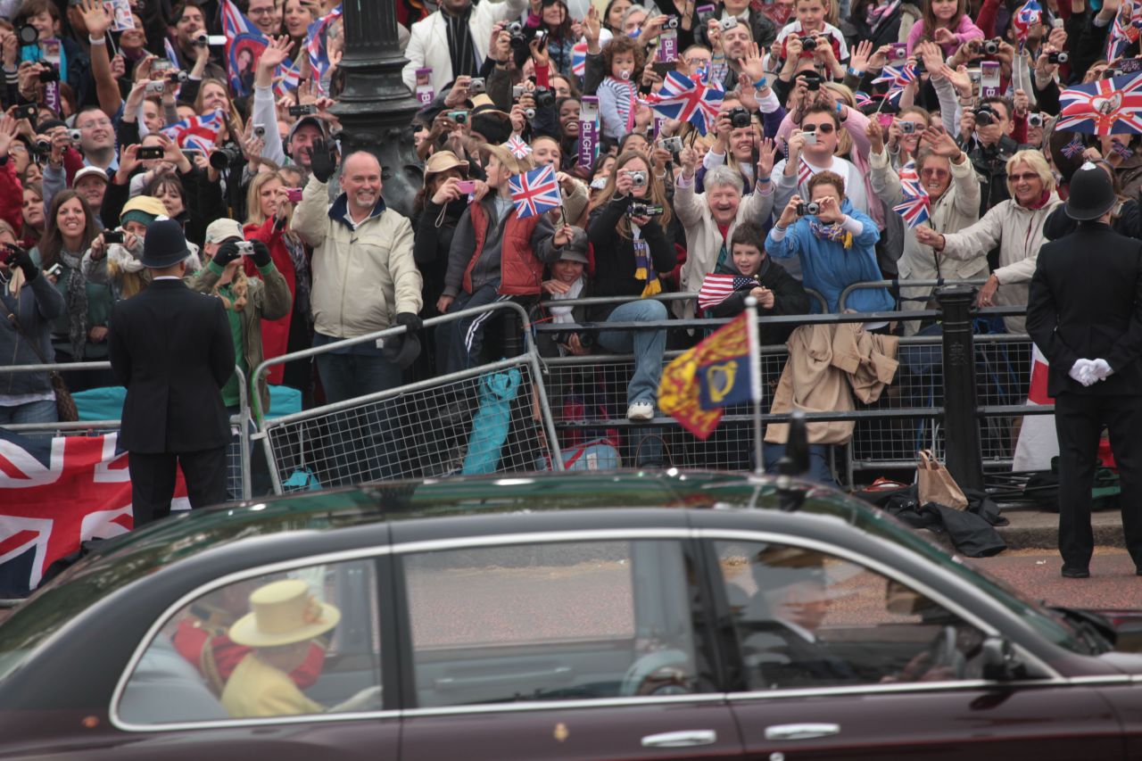 The Queen and Prince Philip drive past fans on the way to Westminster Abbey for the Wedding of William and Kate on April 29, 2011  