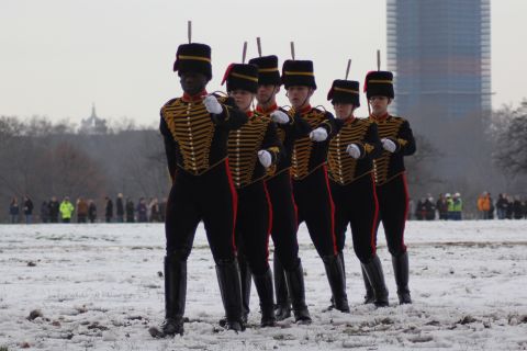 With their army-issue black boots protecting them from the melting snow underfoot, members of the King's Troop march off the field in file.