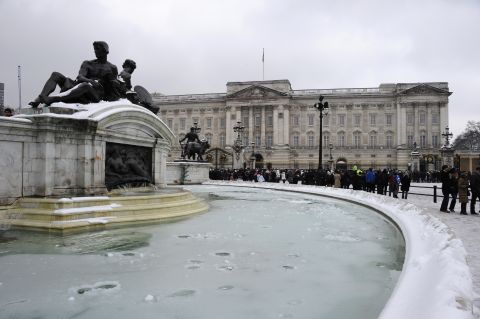 A frozen fountain stands in front of Buckingham Palace in London on Sunday. Heavy snow fell overnight across southeast England, causing many roads to become blocked.