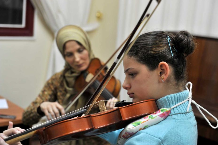 Violin teacher Elena Radwan playing with a student at Gaza Music School