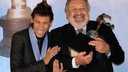Brazilian football player Neymar (L) celebrates with the president of Brazilian club Santos, Luis Alvaro de Oliveira,