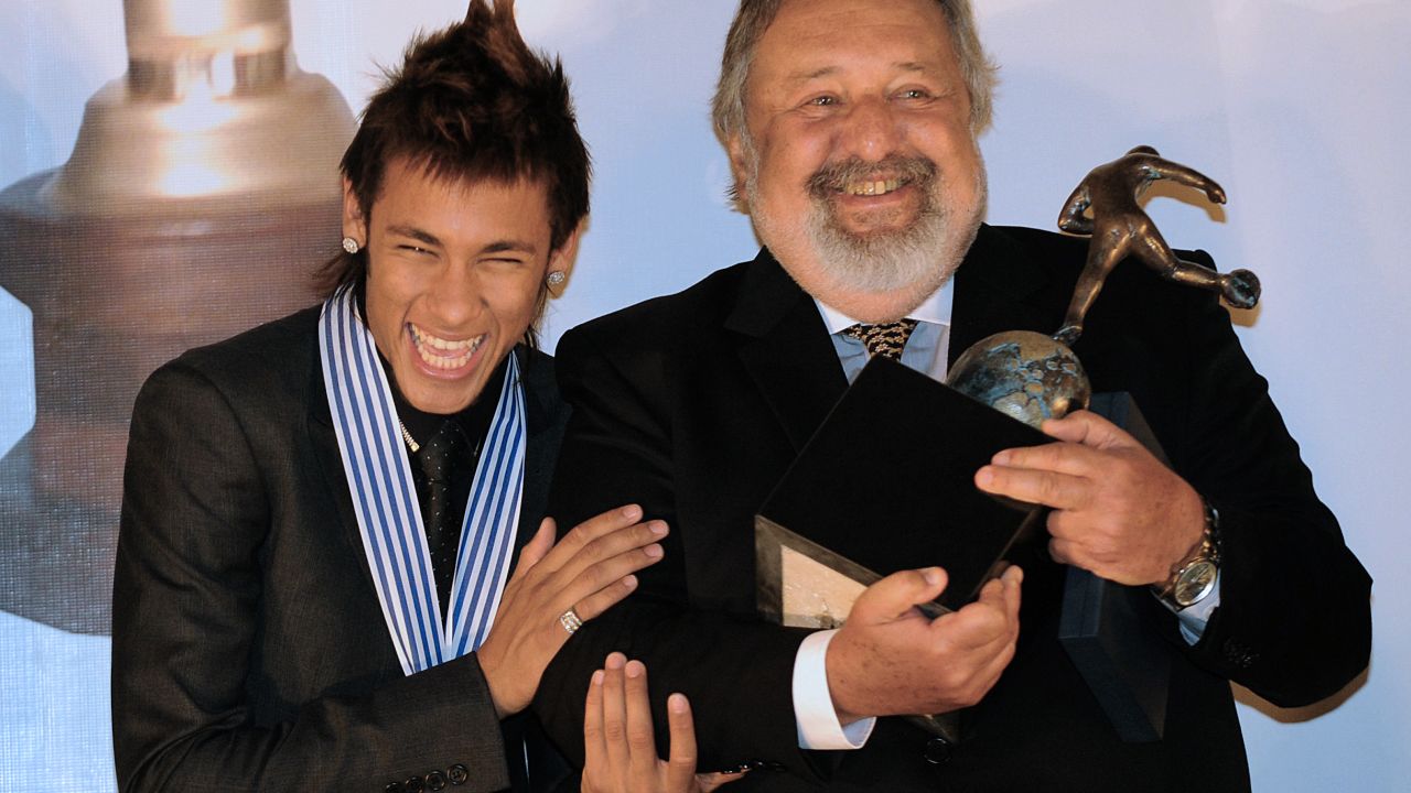 Brazilian football player Neymar (L) celebrates with the president of Brazilian club Santos, Luis Alvaro de Oliveira,
