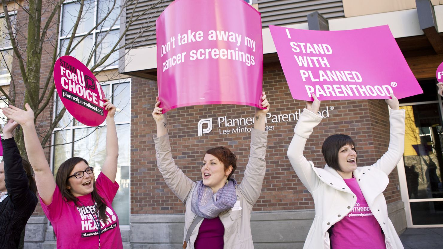 Protesters hold up signs following a press conference by U.S. Sen. Patty Murray outside at a Planned Parenthood Clinic Feb. 3