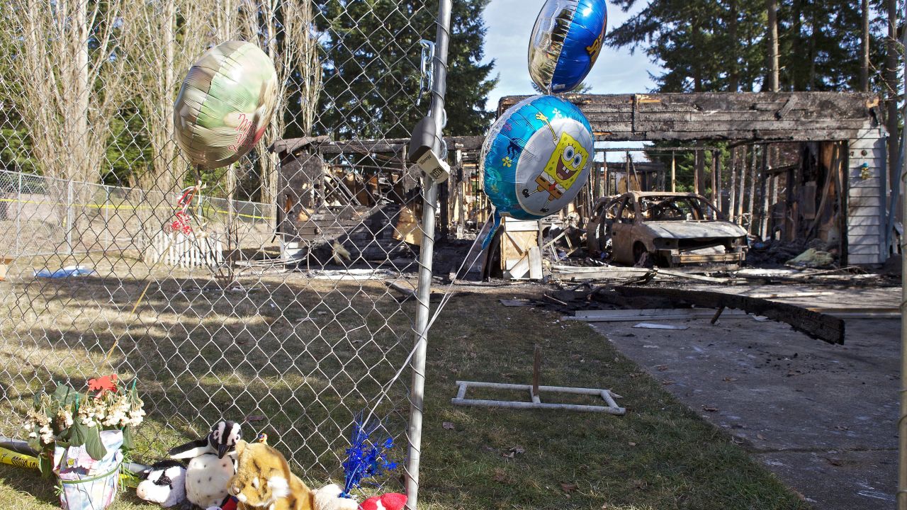 Balloons have been left in front of the charred home of Josh Powell on Tuesday near Graham, Washington..