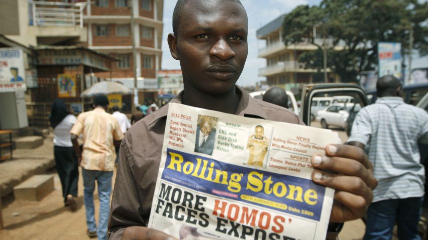 Giles Muhame, managing editor of the Ugandan publication 'Rolling Stone', holds the latest issue of his newspaper on the streets of Kampala, November 3, 2010.