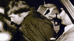 WASHINGTON, UNITED STATES: (FILES): This 30 March 1981 file photo shows John Hinckley Jr. (L) escorted by police in Washington, DC, following his arrest after shooting and seriously wounding then US president Ronald Reagan. A federal judge ruled 17 December 2003 Hinckley can make local visits with his family from St. Elizabeth's Hospital in Washington, DC, where he has been held. AFP PHOTO/FILES (Photo credit should read -/AFP/Getty Images)