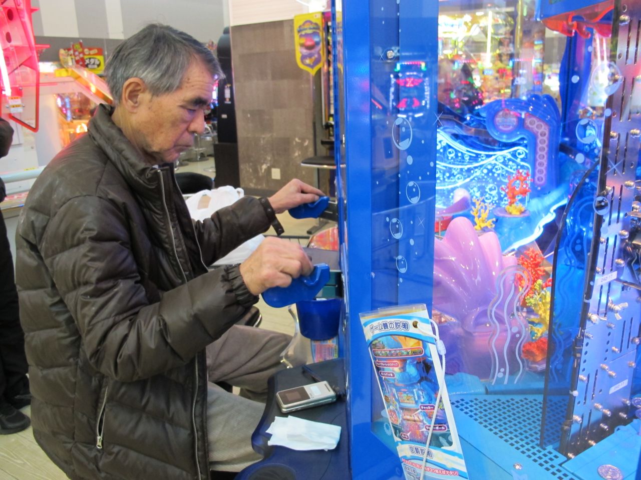 Teruo Kataoka plays a video game at the Sega Game Center in Yokohama, Japan.