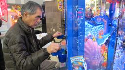 Teruo Kataoka plays a video game at the Sega Game Center in Yokohama, Japan.