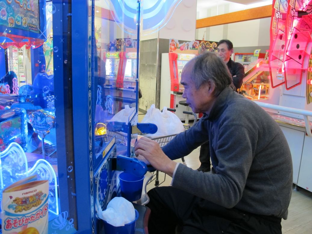 An older gamer plays at the arcade in Yokohama, Japan