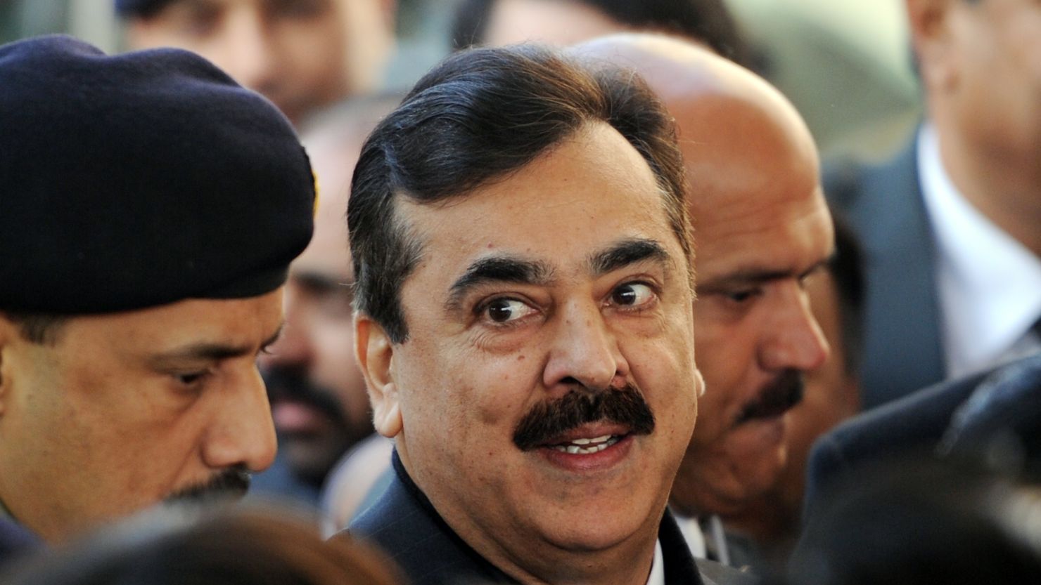 Pakistani Prime Minister Yousuf Raza Gilani, center, arrives at the Supreme Court in Islamabad on January 19. 