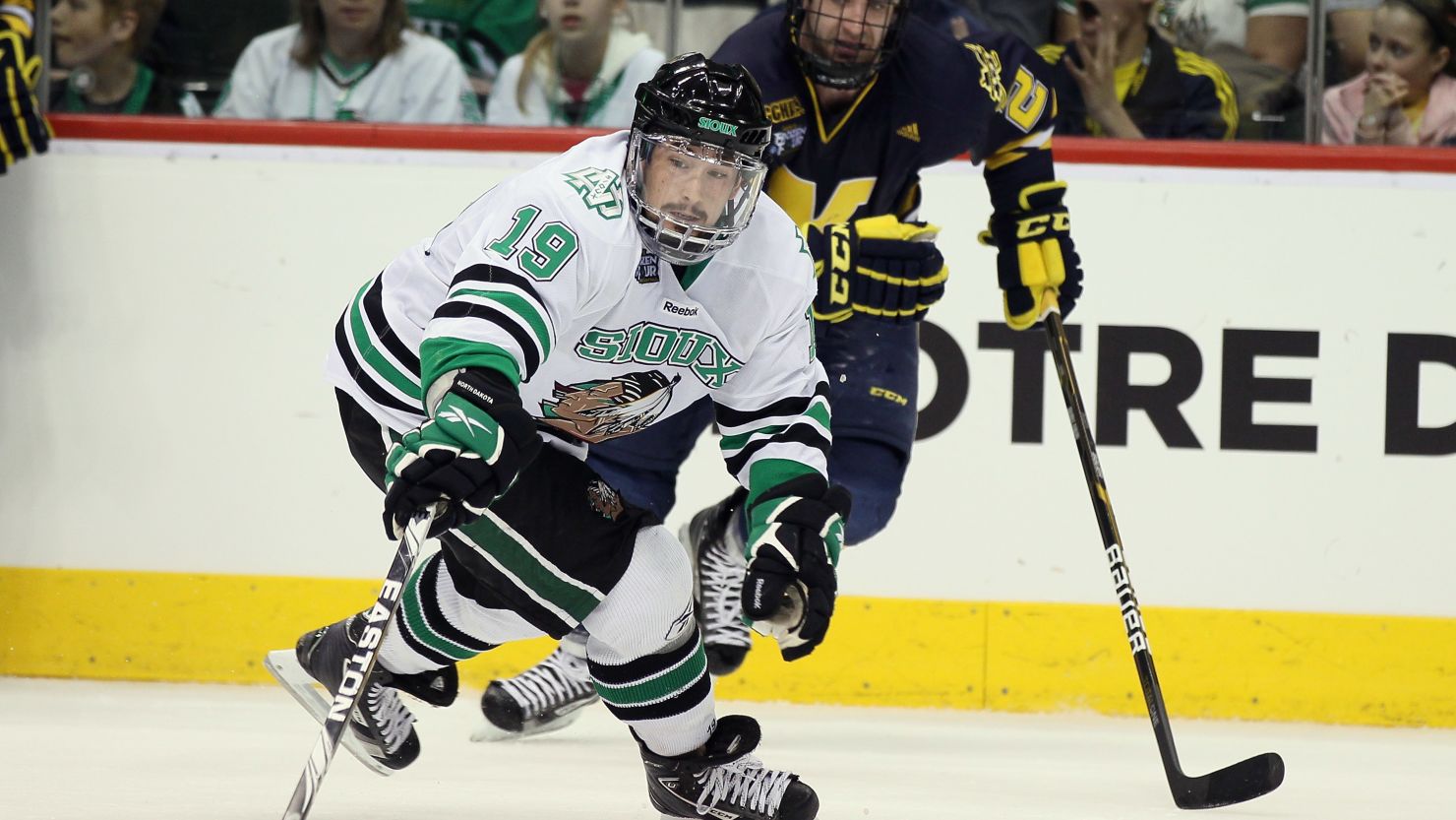 Evan Trupp of the North Dakota Fighting Sioux tries to keep the puck in a game against the Michigan Wolverines on April 7, 2011.