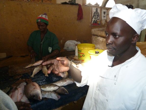 Chef Ishmail N'Dour purchases fish, a key component of "Thiebou Jen," the national dish. 