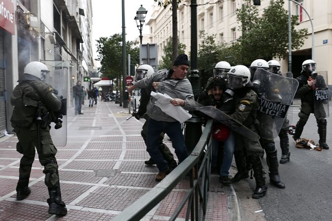 Greek protesters threw stones and firebombs at riot police who responded with tear gas in Athens on February 10 as clashes erupted on the sidelines of a protest against new austerity cuts.