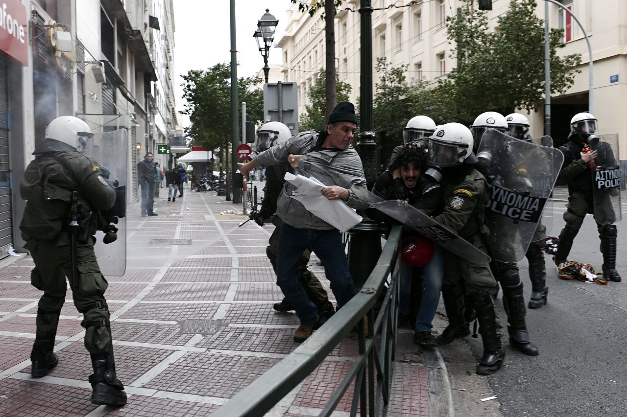 Greek protesters threw stones and firebombs at riot police who responded with tear gas in Athens on February 10 as clashes erupted on the sidelines of a protest against new austerity cuts. 