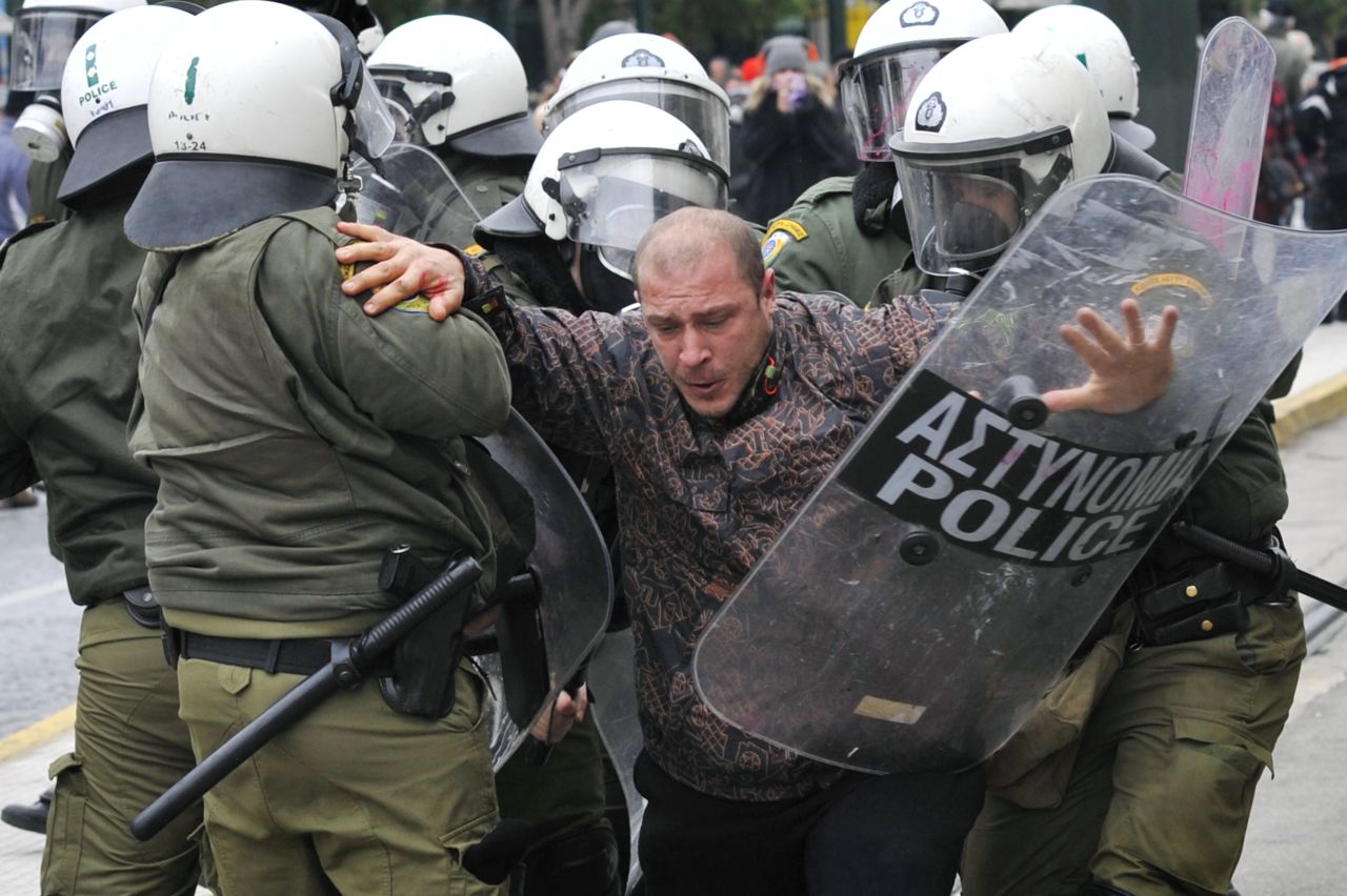 Riot police detain a protester during a 48-hour general strike in Athens on February 10, 2012 in response to new austerity cuts. Greece needs the euro zone ministers to sign off on a new €130 billion ($172.6 billion) bailout deal.
