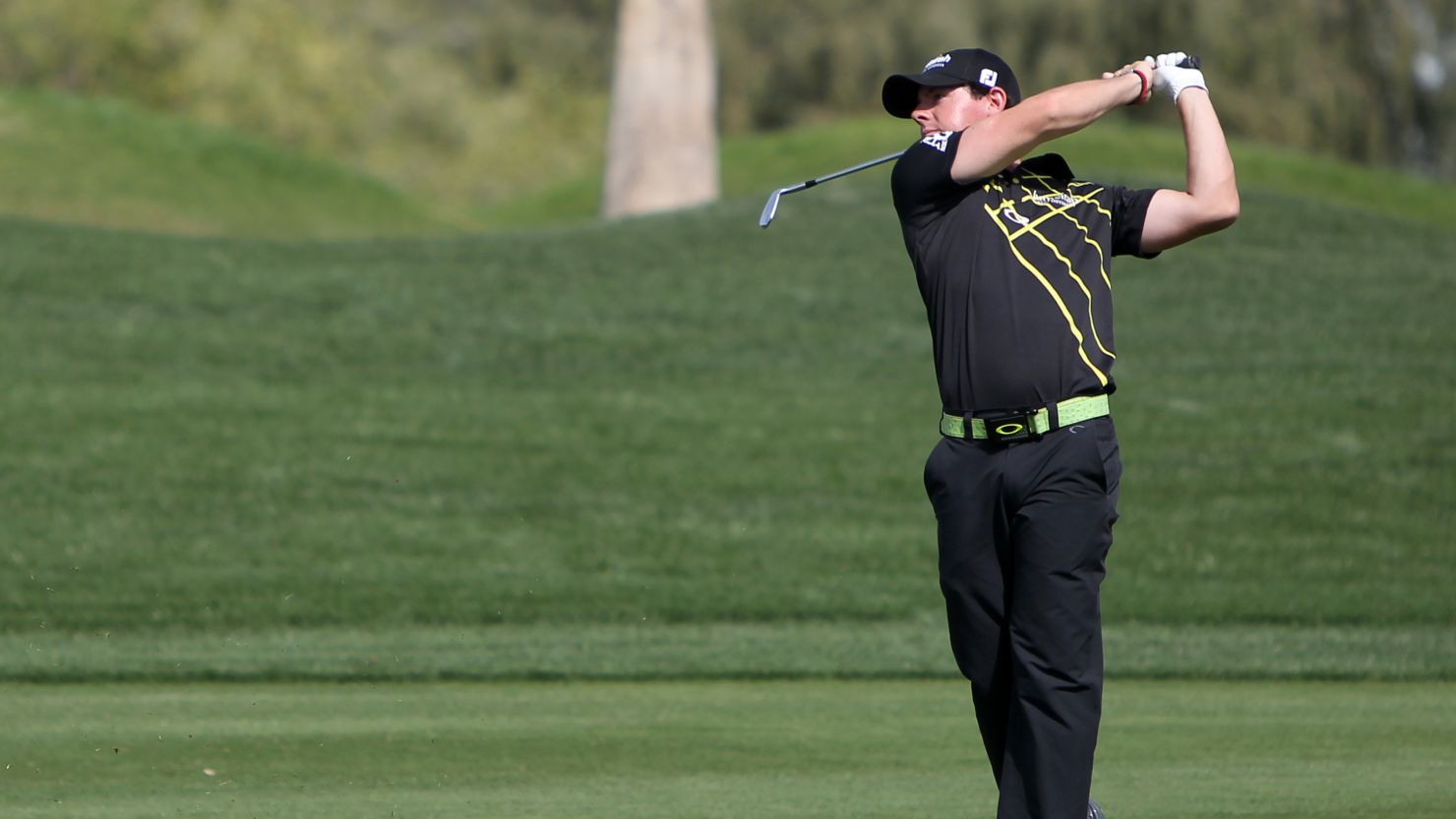 Rory McIlroy plays an approach shot on his way to a second round 65 in Dubai.