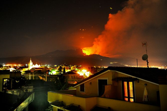 A column of hot ash spews high into the sky from Italy's Mount Etna on the Mediterranean island of Sicily