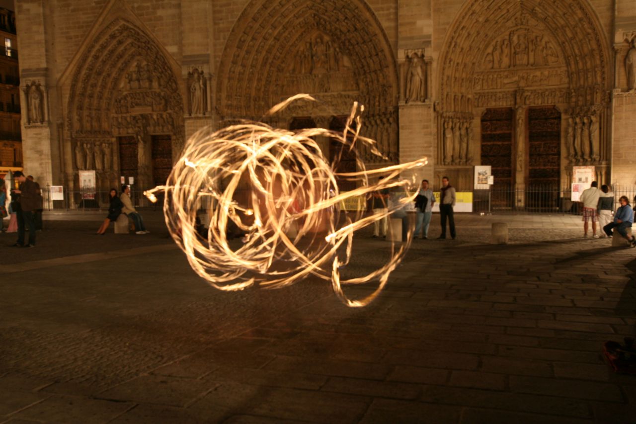 Robert S. Ondrovic shot this photo of "a street performer outside of Notre Dame who was juggling batons that were on fire on a beautiful summer evening at midnight." The long exposure caused the juggler to appear transparent.