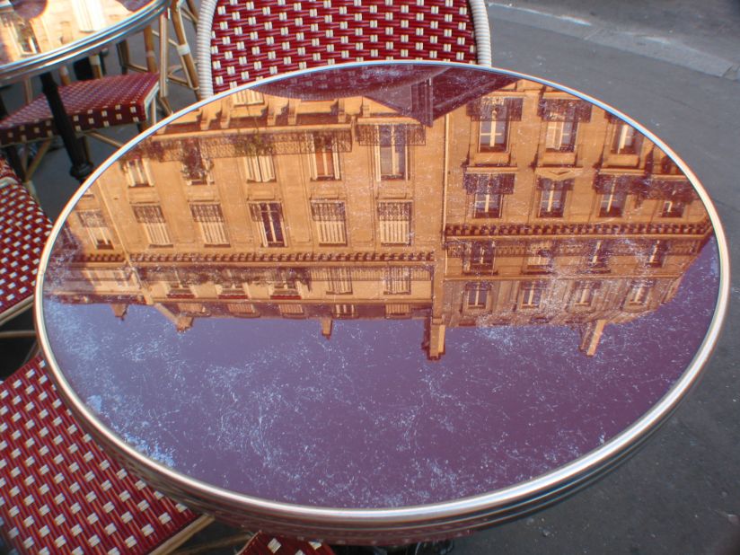 Gary Hill captured this interesting perspective while on a home exchange vacation. "Those quiet moments in the early morning, just soaking in the soul of the city, are my favorite memories of the trip. One morning I looked down and saw this reflection on the cafe table and taking the picture has allowed me to reflect on those wonderful memories over and over again."