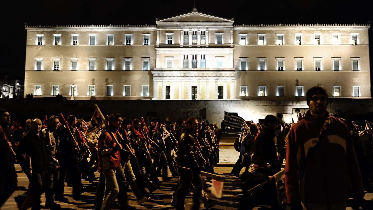 Protesters march against austerity cuts Thursday in front of the Greek Parliament in Athens.