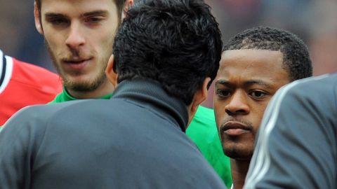 Patrice Evra and Luis Suarez (second left) fail to shake hands before the start of an English Premier League game.