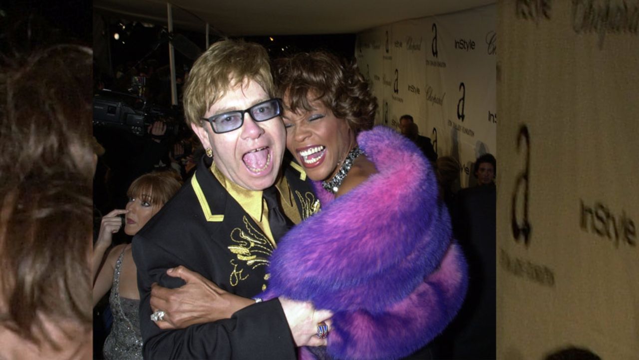 Elton John and Houston embrace  during the  Academy Awards show in Los Angeles in March 2001.   
