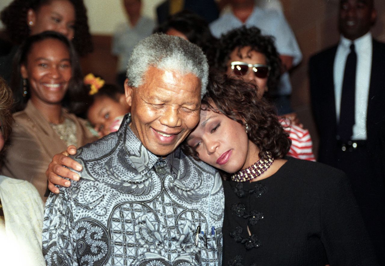 South African President Nelson Mandela hugs Houston in November 1994.