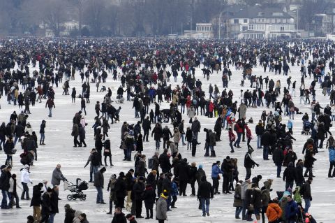 People walk on the frozen Aussenalster river during the 'Alstervergnuegen' on February 11, 2012 in Hamburg, Germany. The very popular annual city festival 'Alstervergnuegen' takes place around the Alster lake in Hamburg. 