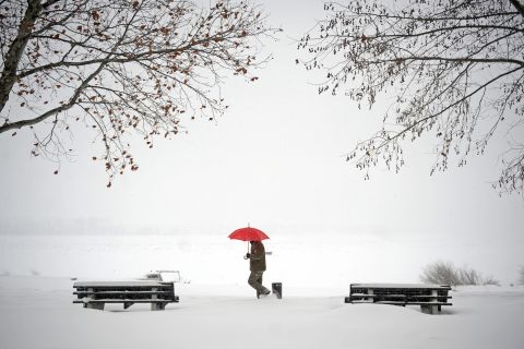 A man walks through snow covered banks of the Danube river in Zemun near Belgrade on February 12, 2012. Cold weather claimed seven more lives on Sunday in the Balkans -- two in Albania, one in Serbia and Bosnia respectively, while three more victims of an avalanche that buried several houses in a southern Kosovo village were found. 