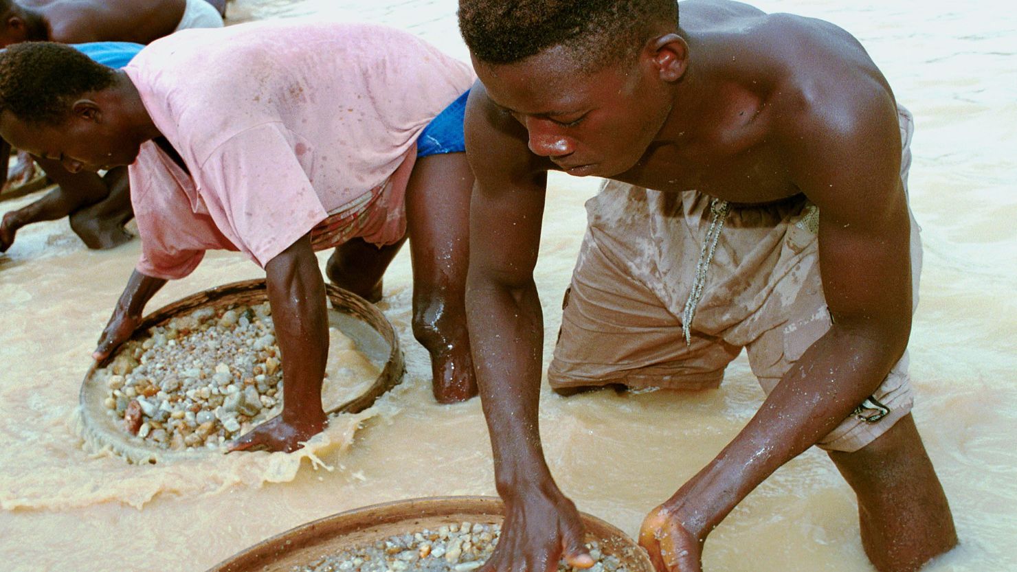 Workers pan for diamonds in a government-controlled diamond mine near Kenema, Sierra Leone, in 2001.