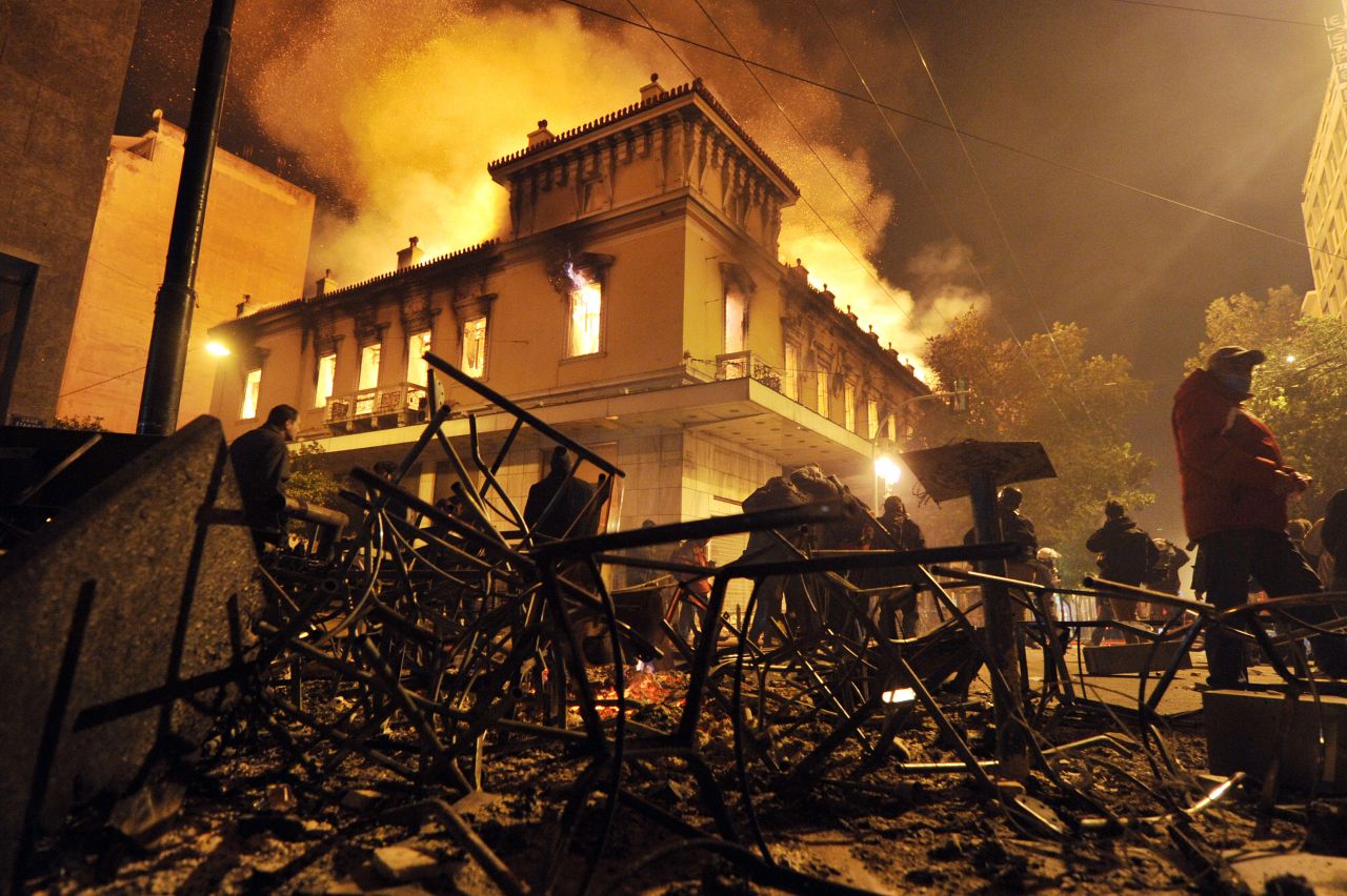 A fire engulfs a store during clashes between protesters and riot police near the Greek parliament in Athens 